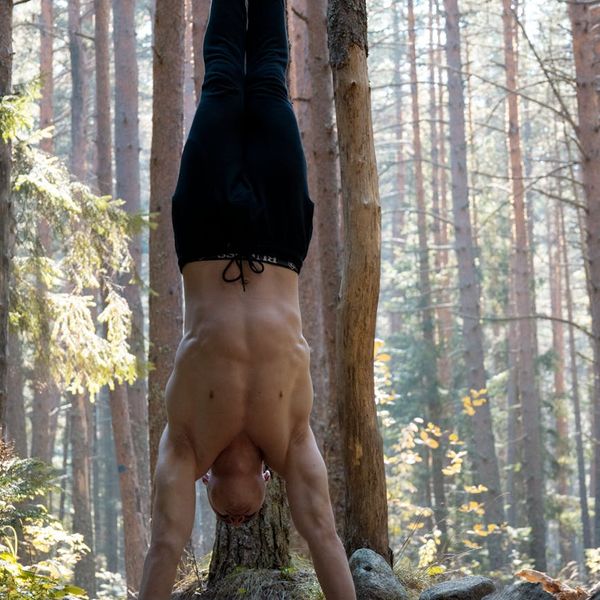Man stretching outdoors at sunrise, feeling energized and balanced.